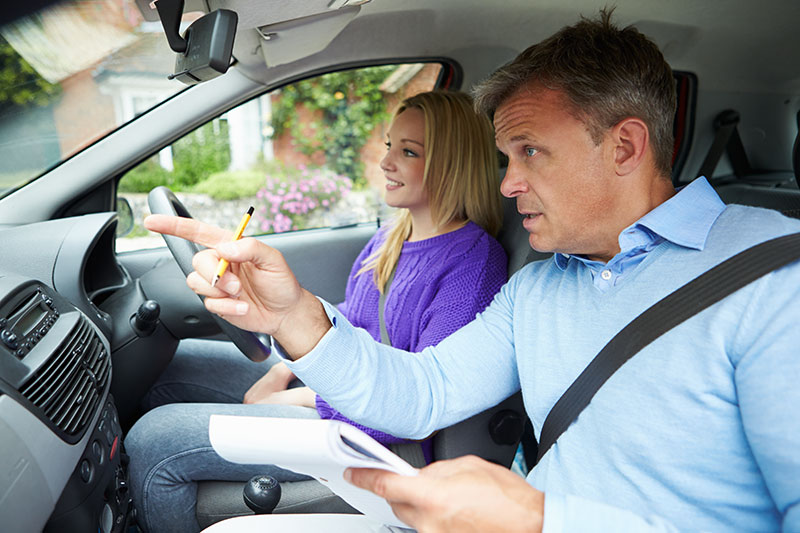 an instructor teaching a driving student